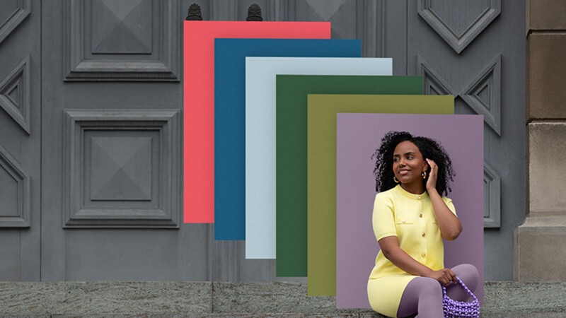 A woman is sitting on a flight of stairs wearing colour-coordinated compression garments; behind her are overlapping patches of colour in various trendy shades.