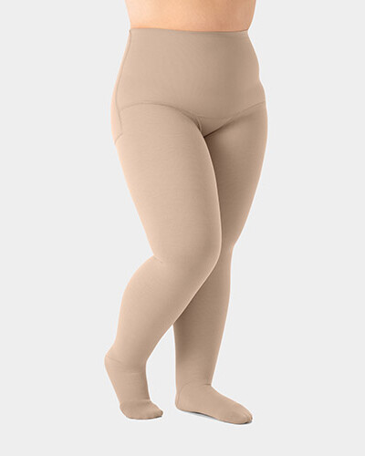 Parte das pernas de uma pessoa que usa a meia-calça de compressão Juzo Expert e está ligeiramente de lado.