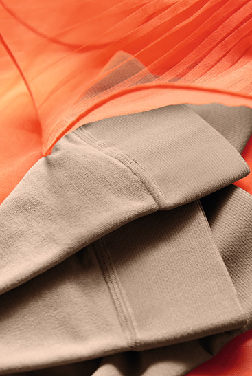 Juzo Inspiration tights lie on an orange tulle Dress