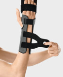 Palmar Xtec Rhizo wrist orthosis being fastened with micro touch fasteners