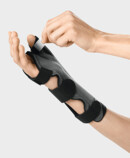 The thumb pocket of the Palmar Xtec Rhizo wrist orthosis being fastened in place