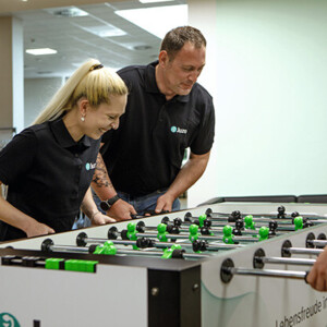 A man and a woman playing kicker A man and a woman playing kicker