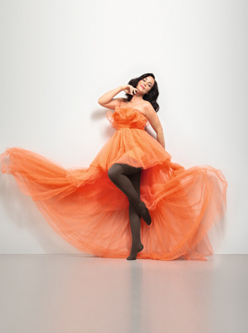Woman with Juzo Inspiration and tights in cocoa and orange dress
