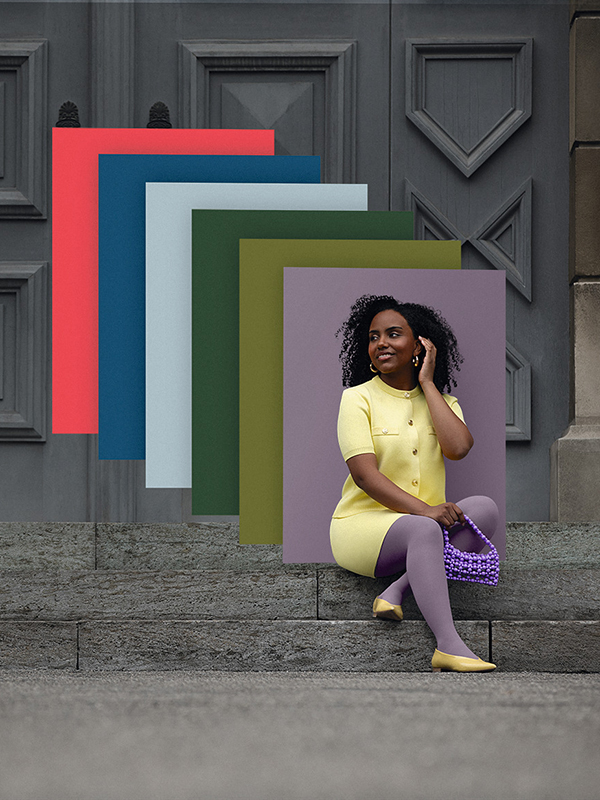 Juzo Trend Colours Batik A woman sits on stone steps in front of a gate. She wears a light yellow two-piece outfit with a purple compression garment. Behind her, you can see colour fields in the trend colours.