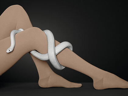 Juzo Move One leg with a compression stocking. A snake winds around the leg.