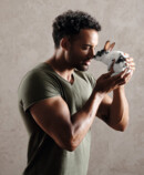 1. Lifestyle image Juzo Intenso Strong man cuddling with a cute bunny